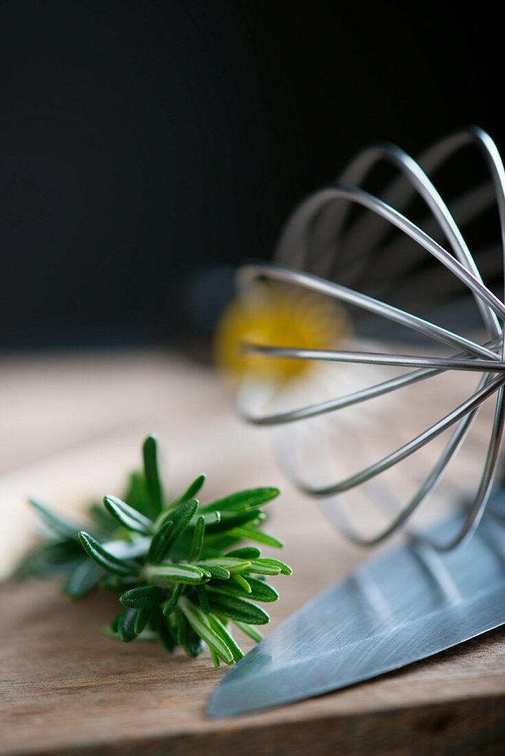 Rosemary, an egg whisk and a knife