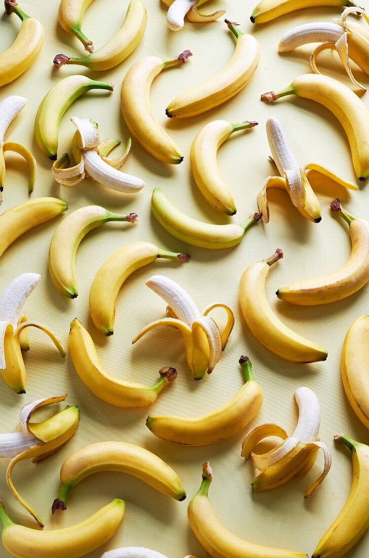 Lots of bananas, whole and partly peeled