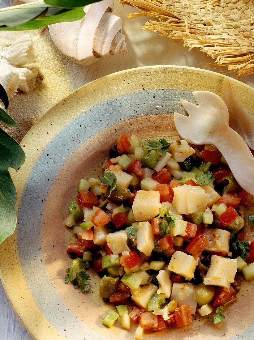 Stockfish salad with green olives, capers, tomatoes, cucumbers