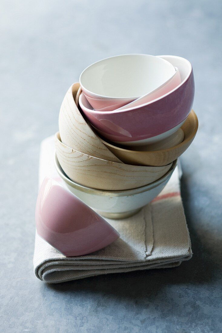 A stack of cereal bowls on a tea towel