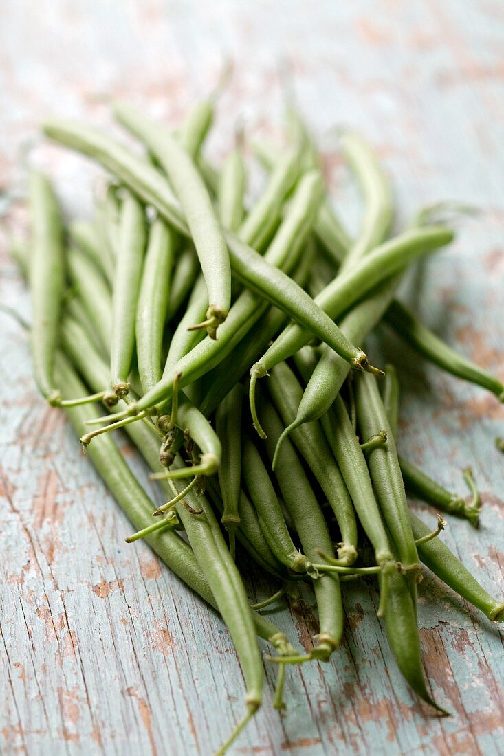 Green beans on a wooden background