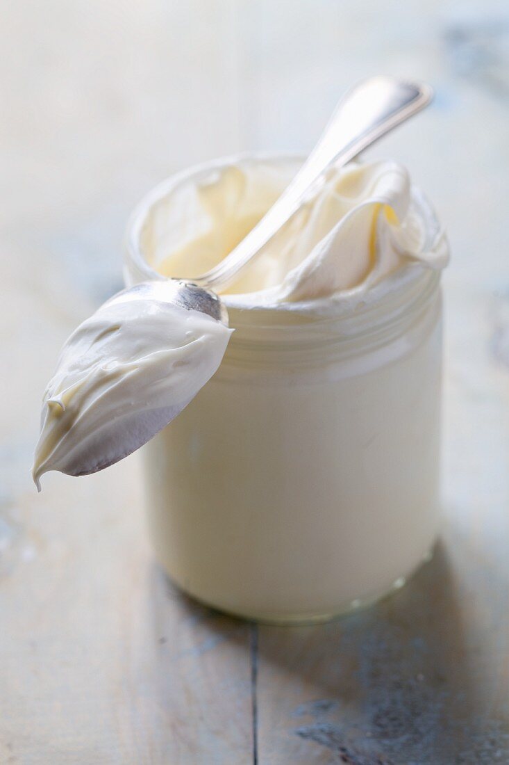 Crème fraîche in a jar with a spoon