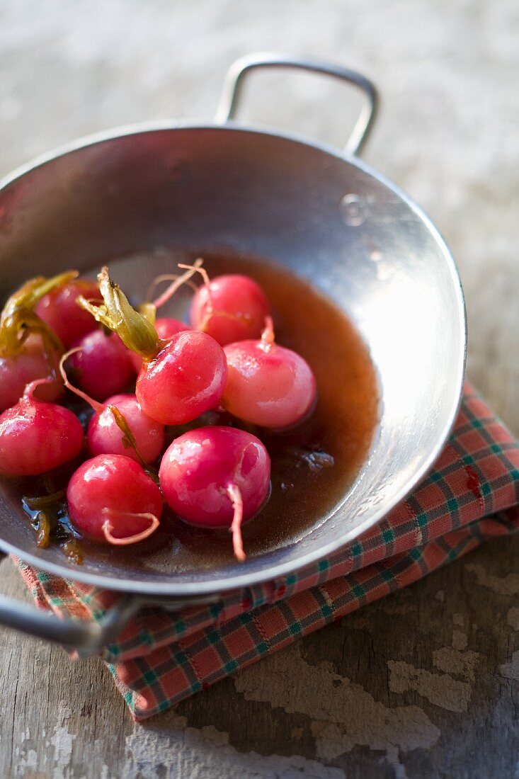 Cooked radishes and white turnips in a sauce