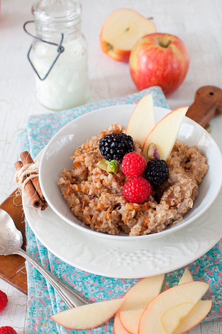 A Bowl of Oatmeal with Apples, Berries and Cinnamon
