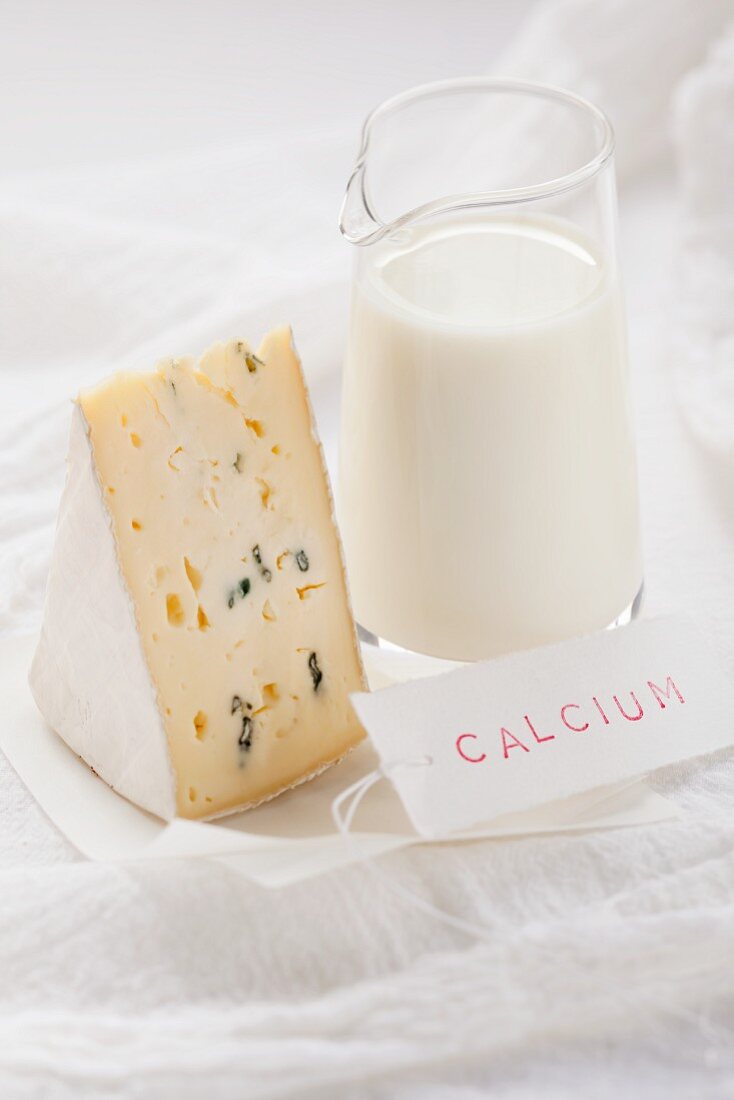 Blue cheese and milk with a sign reading 'calcium'