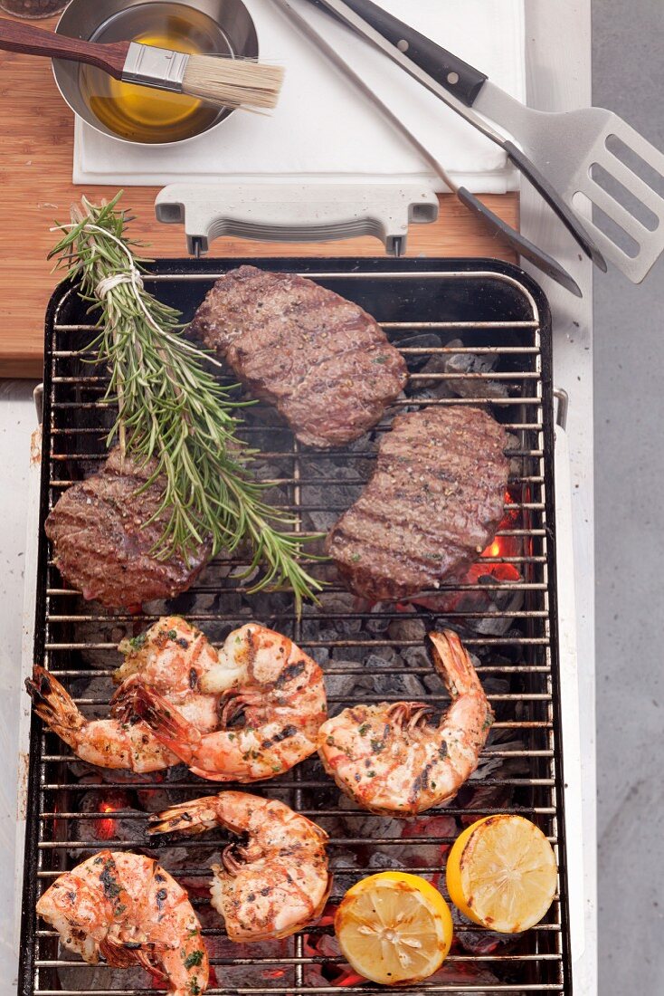 Grilled king prawns and steak on the barbecue grill
