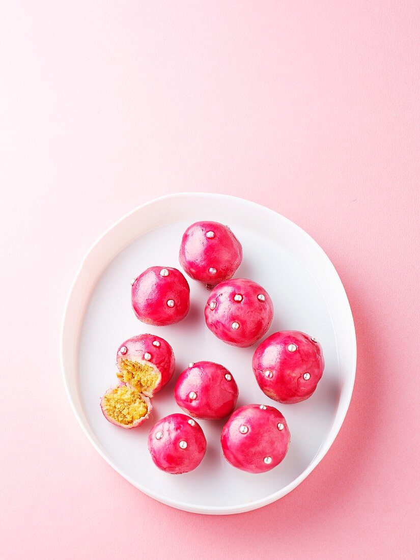 Marzipan and mascarpone sweets with bright pink coating