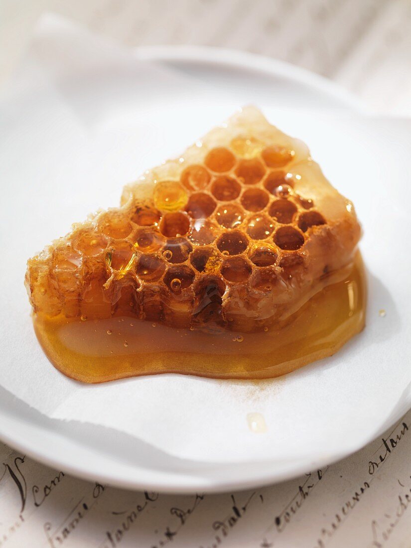 Honey with honeycomb on plate