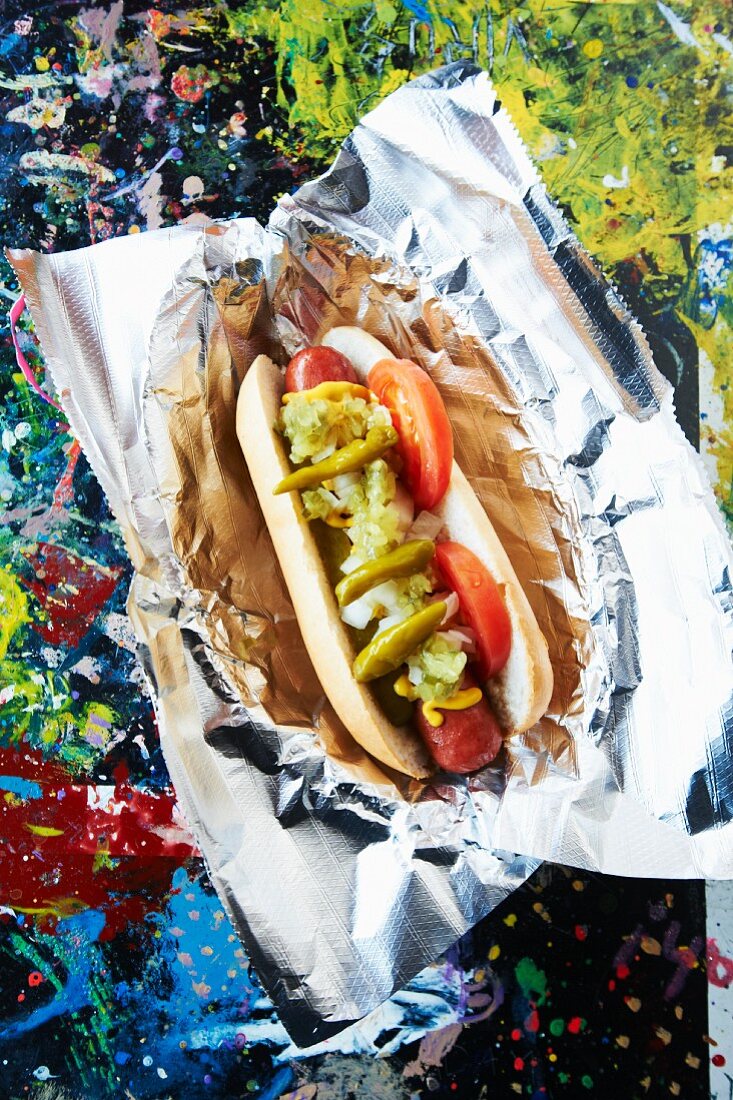 Smoked Hot Dog with Relish, Tomatoes, Mustard and Hot Pickled Peppers
