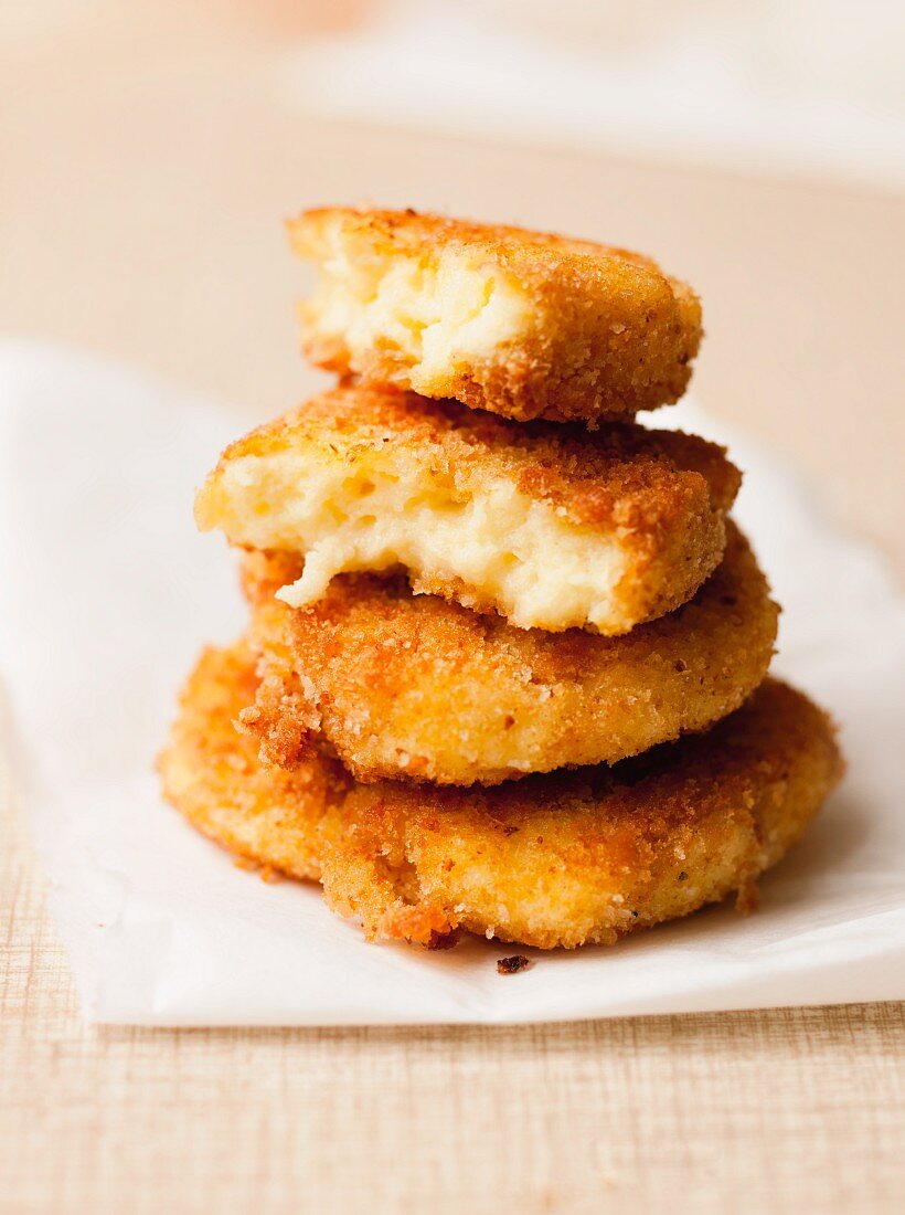 A stack of fried semolina cakes