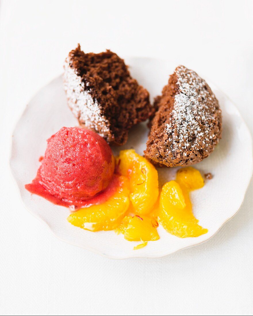 Chocolate muffin with raspberry ice cream and mandarin segments