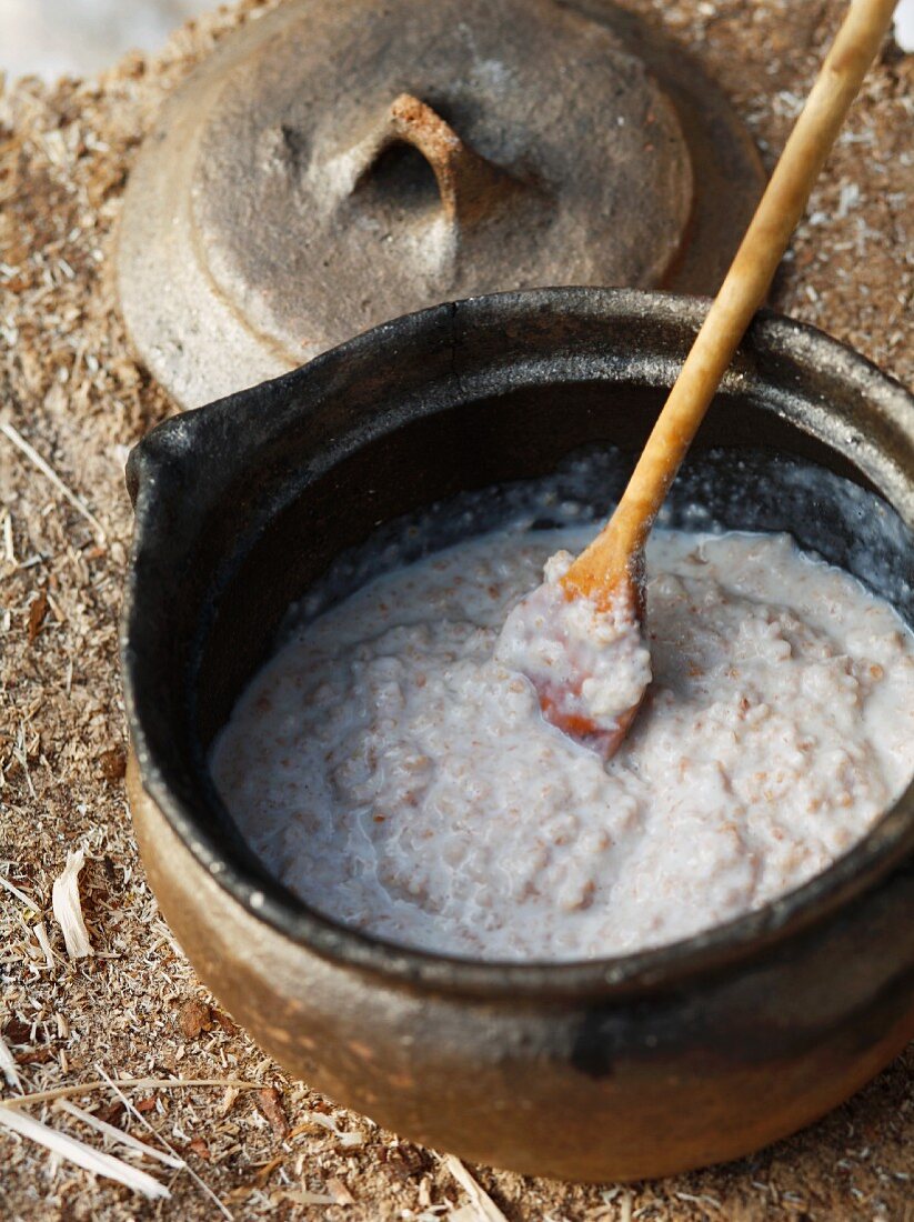 Spelt porridge in a rustic clay pot