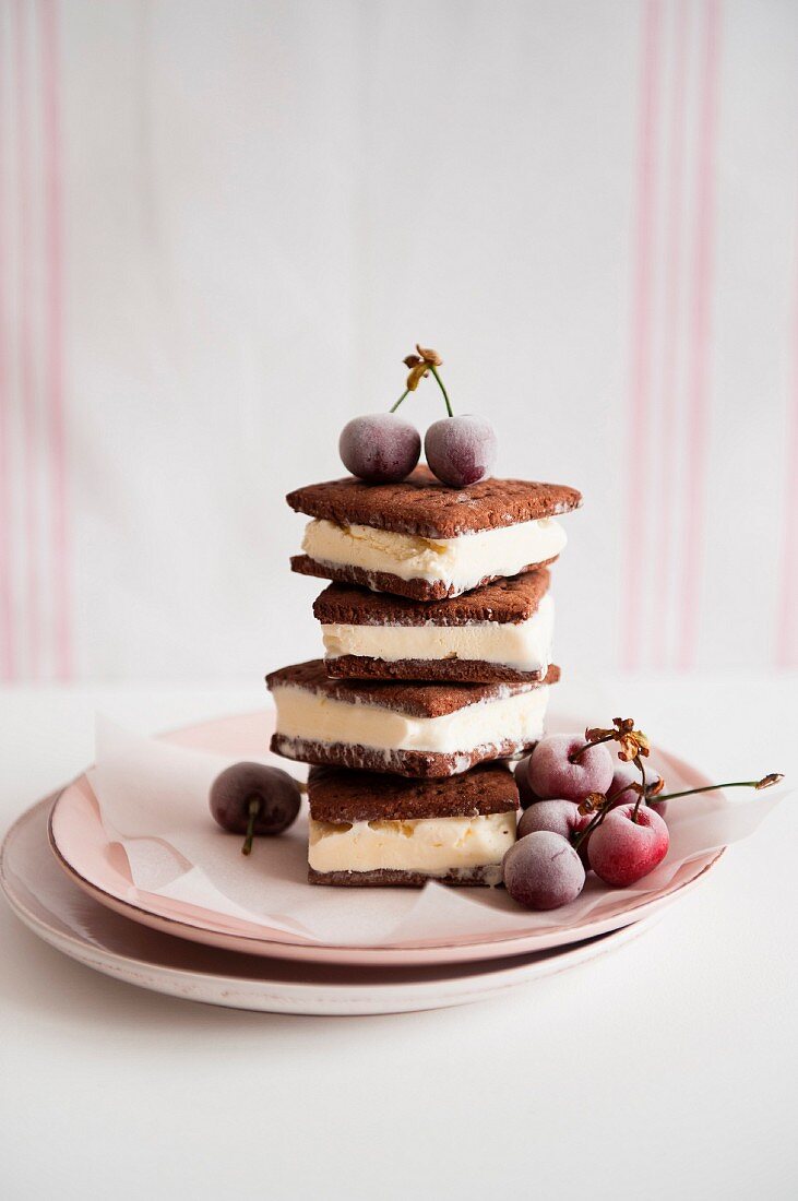 A stack of ice cream sandwiches with frozen cherries