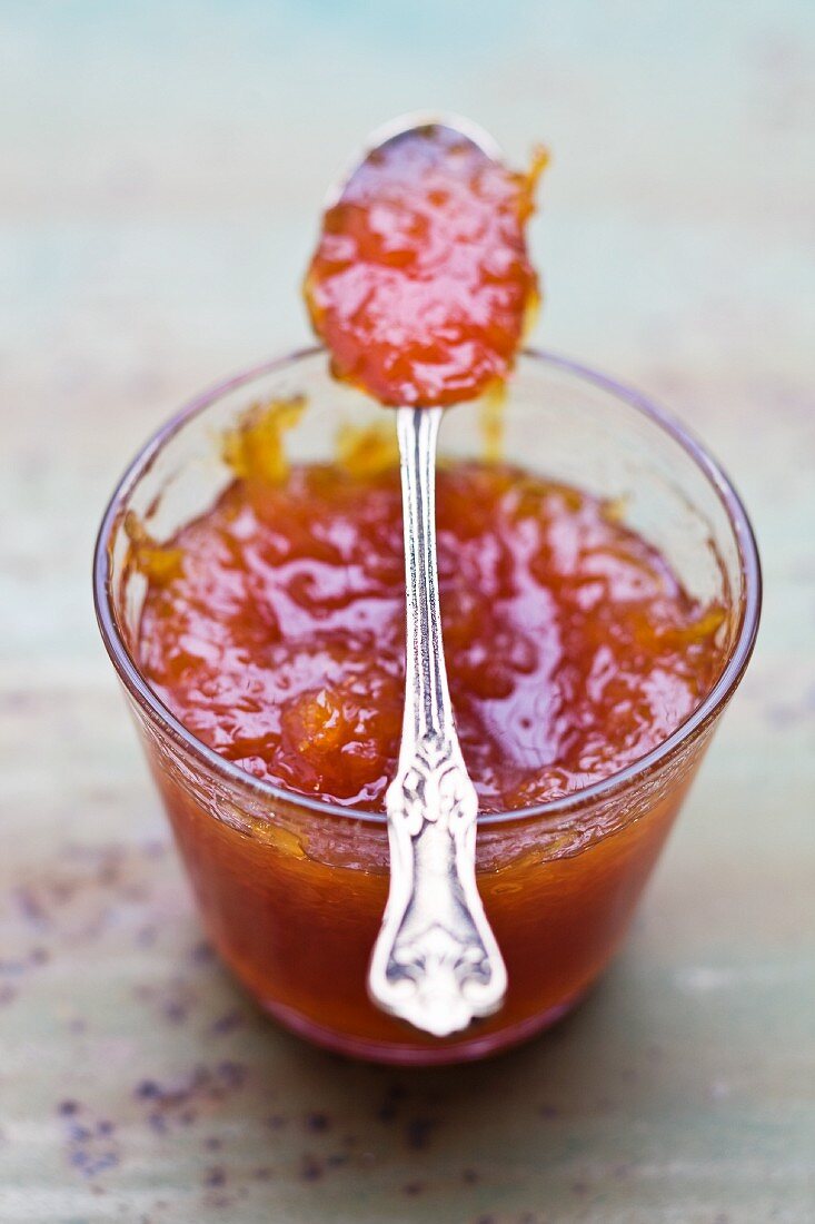 Grapefruit marmalade in a jar with a spoon