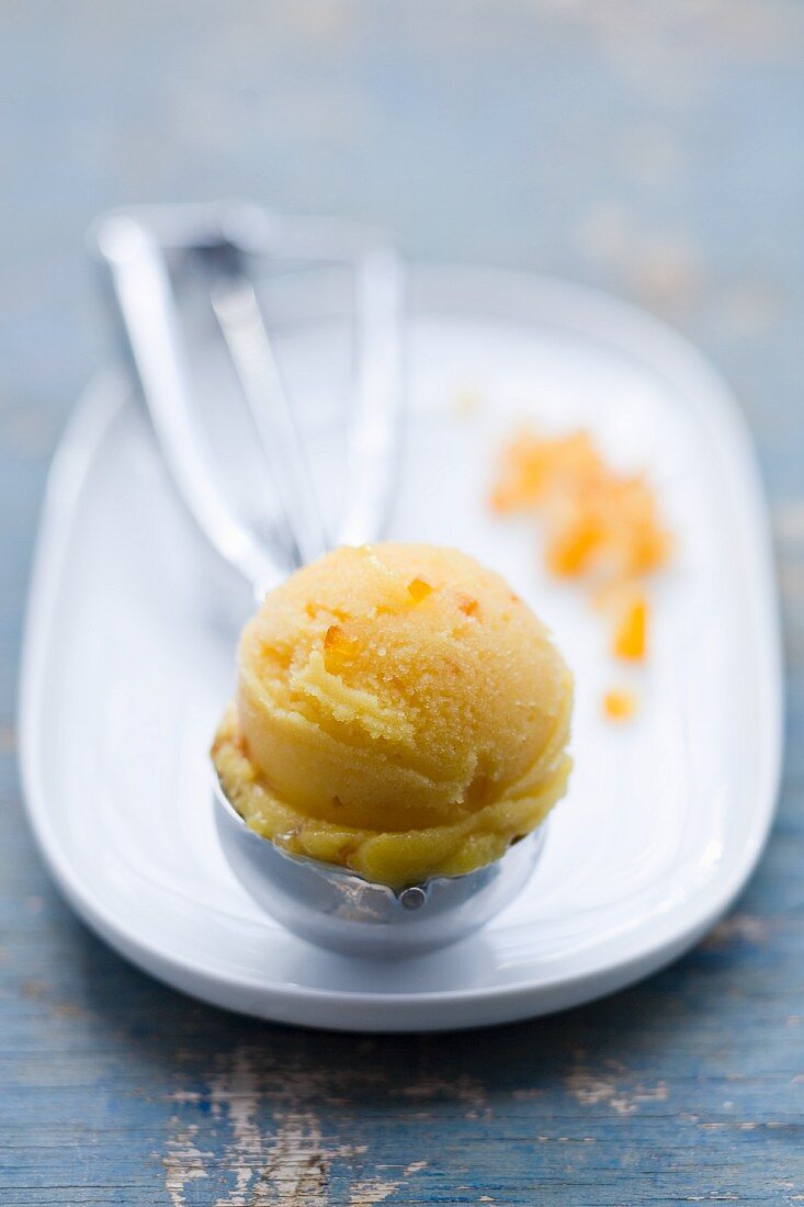 Clementine ice cream in an ice cream scoop