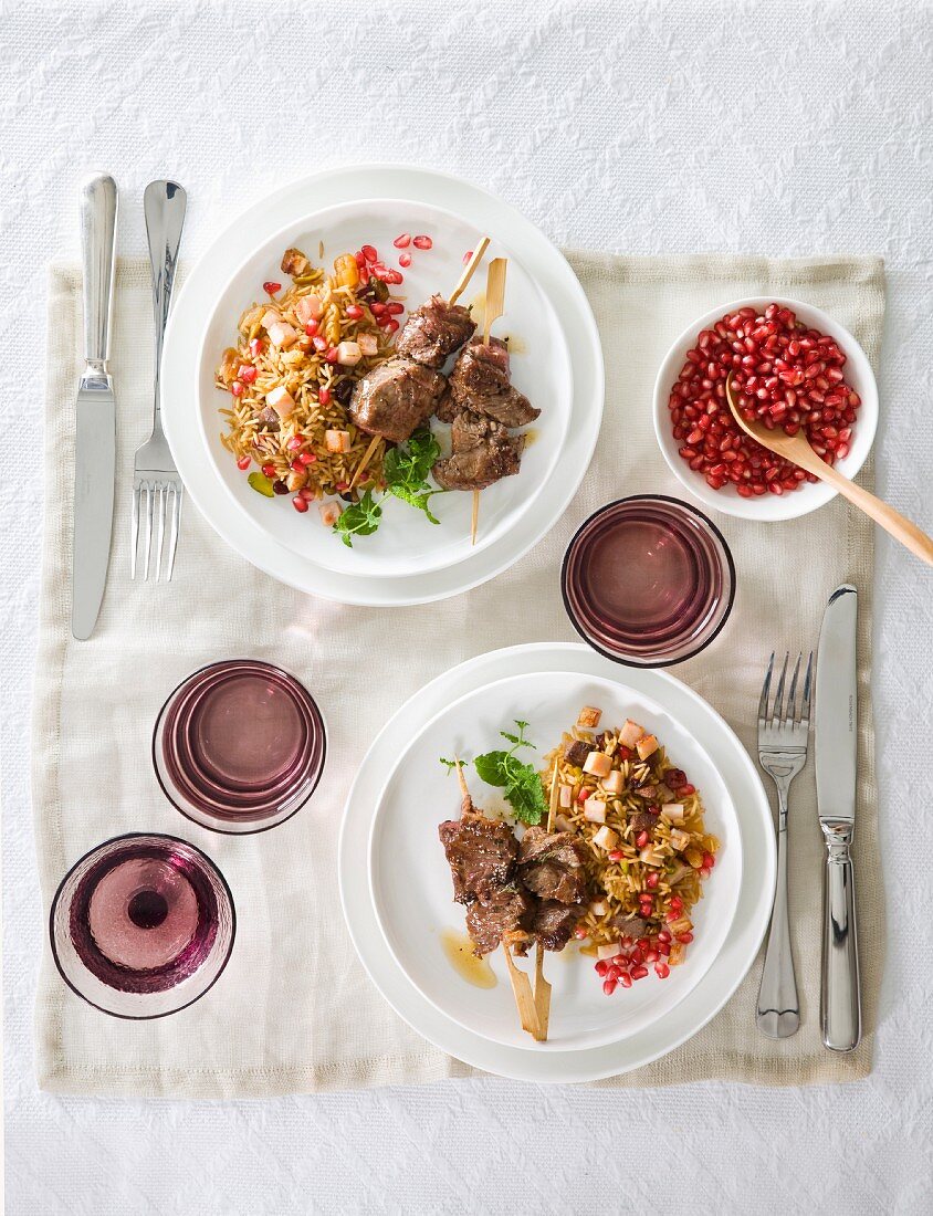 Lamb kebabs with rice and pomegranate seeds