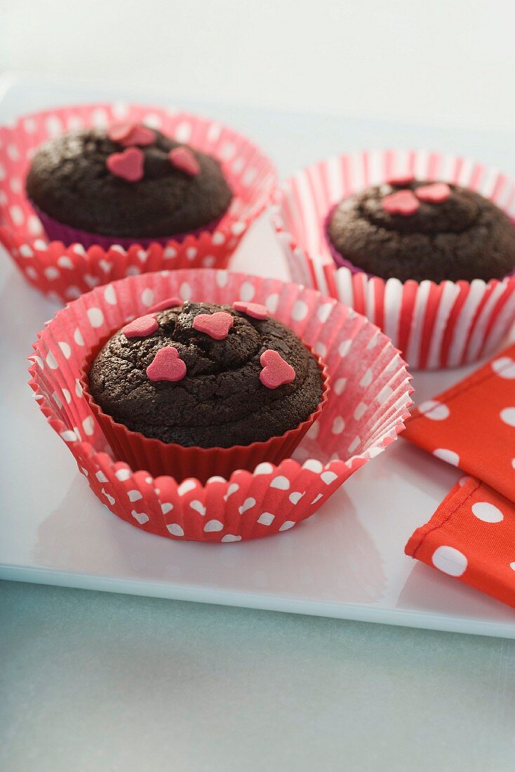 Chocolate muffins topped with sugar hearts