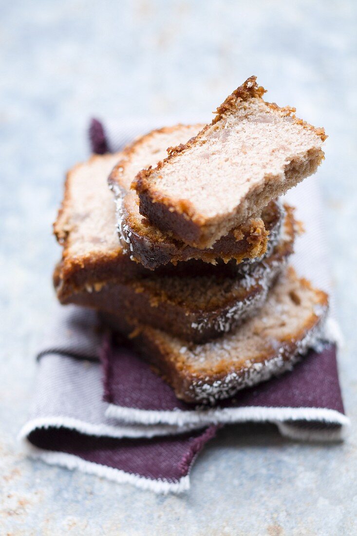 Several slices of chestnut and coconut cake, stacked