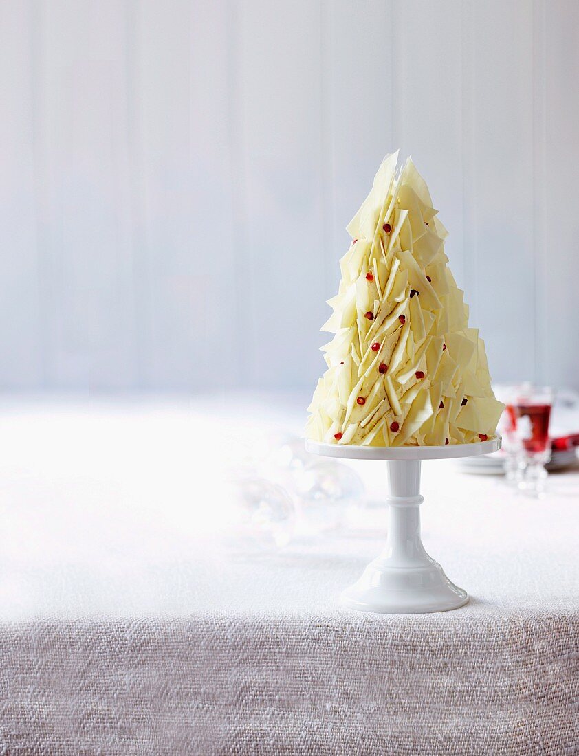 A white chocolate cake in the shape of a Christmas tree