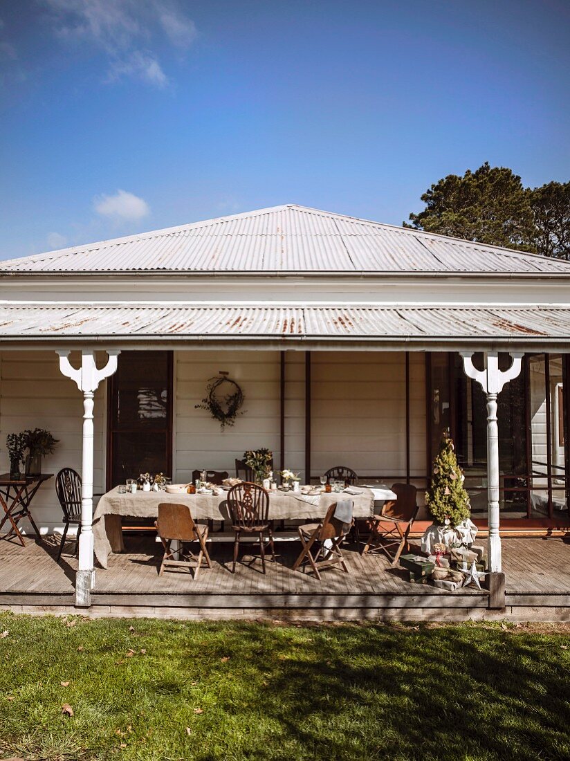 Table & chairs on roofed veranda on sunny winter day