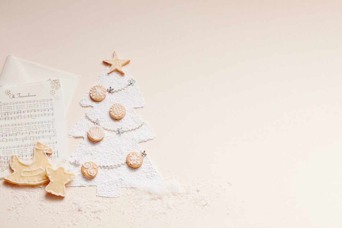 Sheet music, biscuits and a Christmas tree made from icing sugar