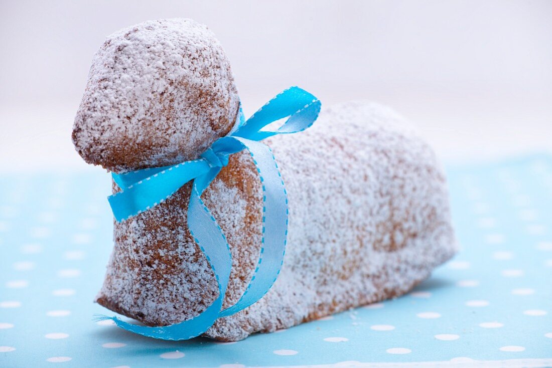 A sweet Easter lamb cake with a blue ribbon