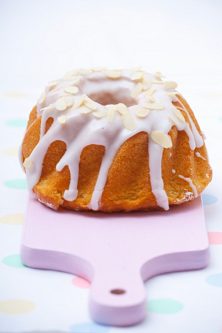 Babka (Easter cake, Poland) with white icing and sliced almonds