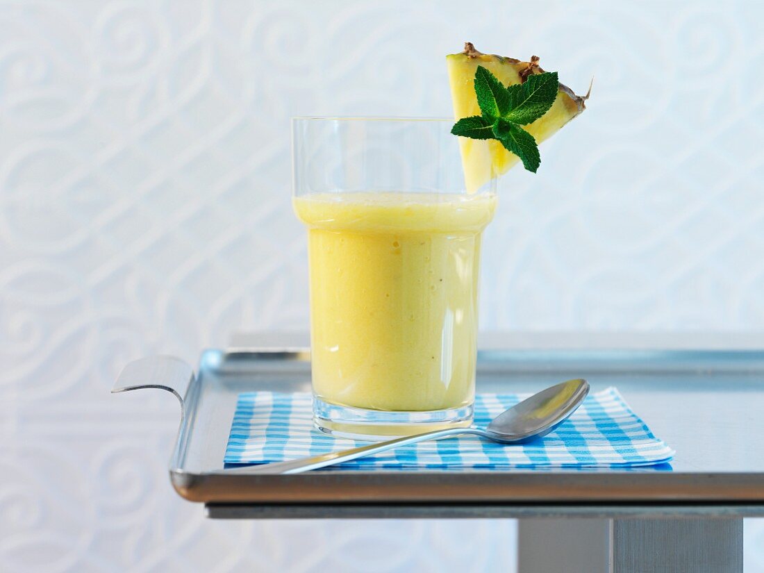 A glass of pineapple and banana smoothie