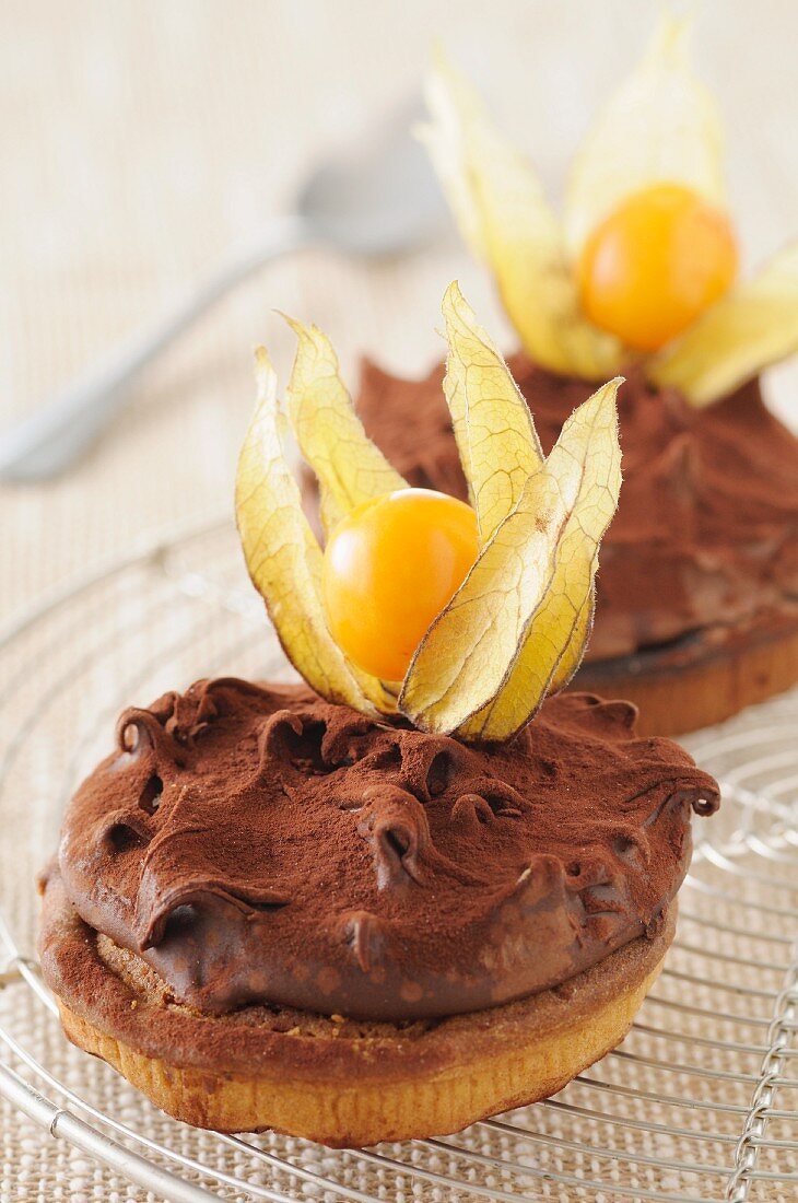 Sable biscuits topped with ganache and physalis
