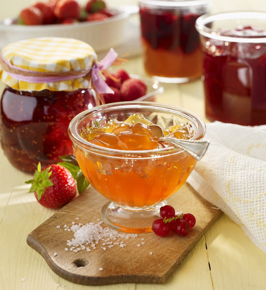 Assorted jams in jars and in a glass bowl
