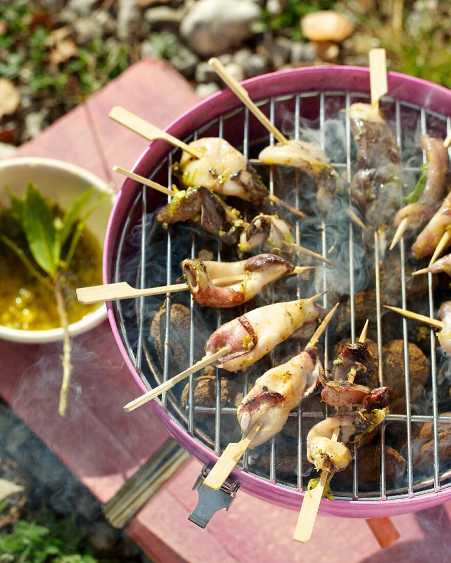 Mini squid skewers on the barbecue