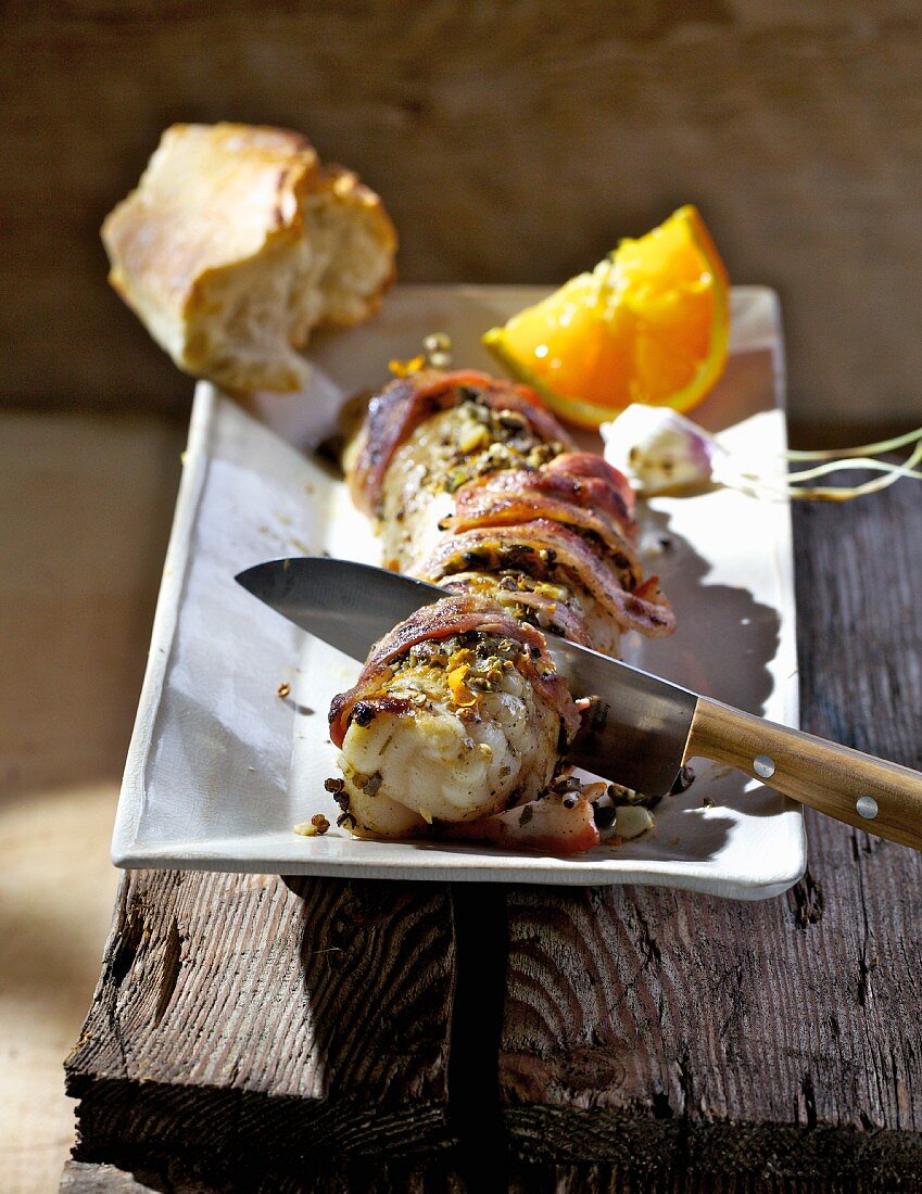 Barbecued monk fish wrapped in bacon