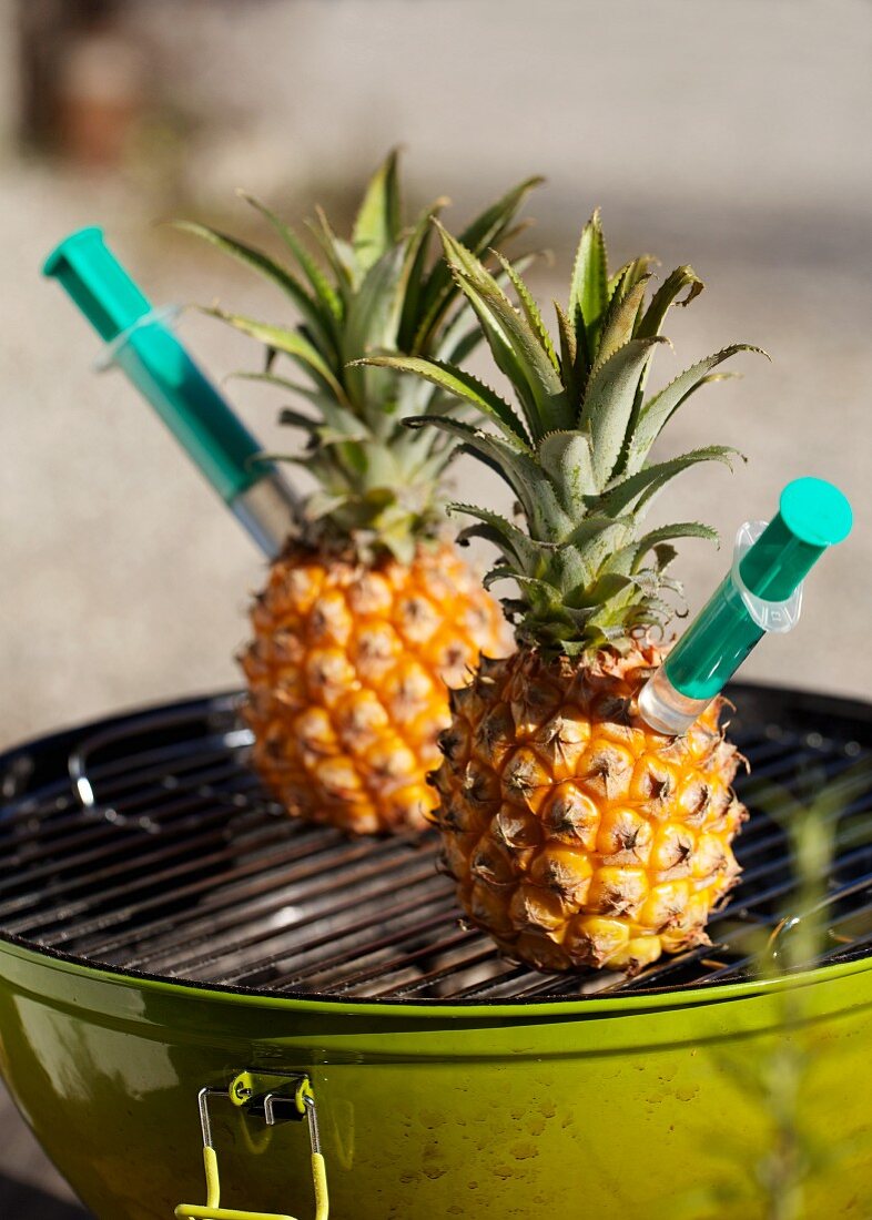 Pineapples infused with vodka, on the barbecue