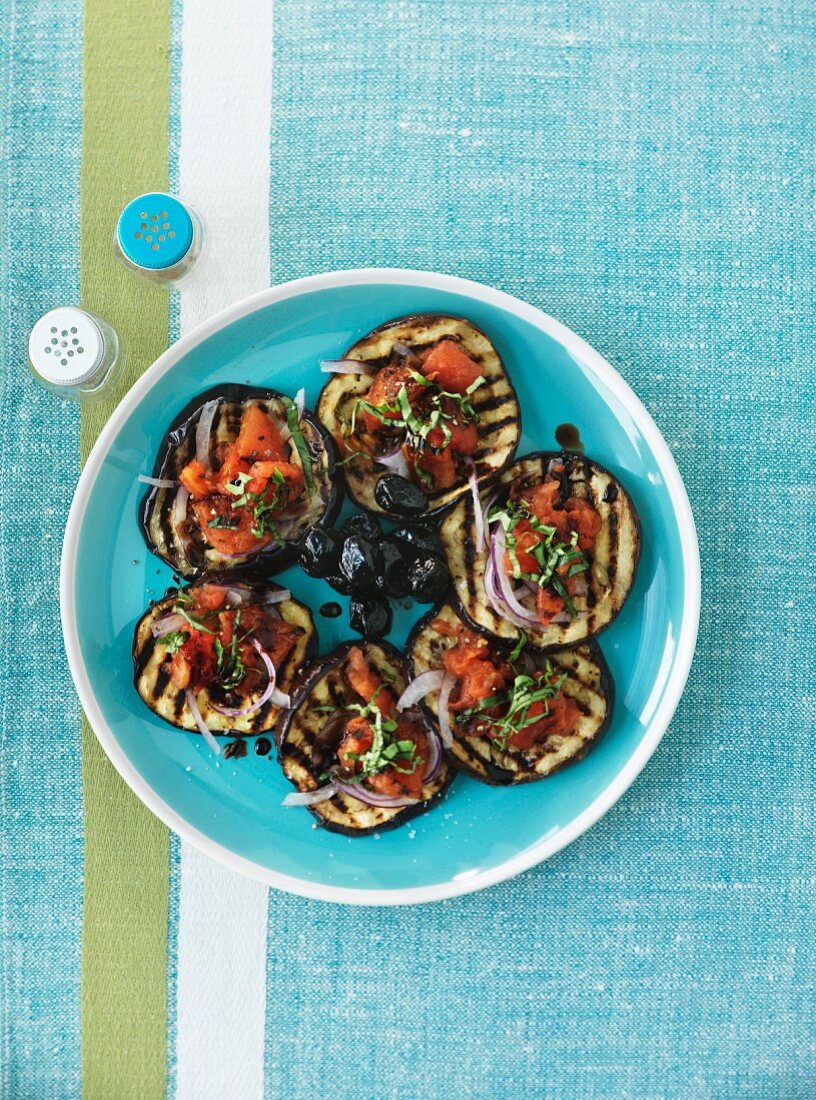 Barbecued aubergines with tomato salad and black olives