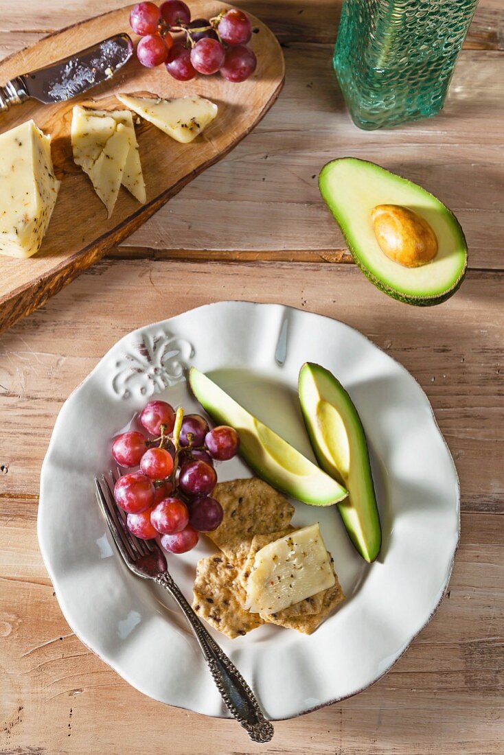 Gluten Free Crackers with Garlic and Herb Cheddar Cheese, Avocado and Red Grapes