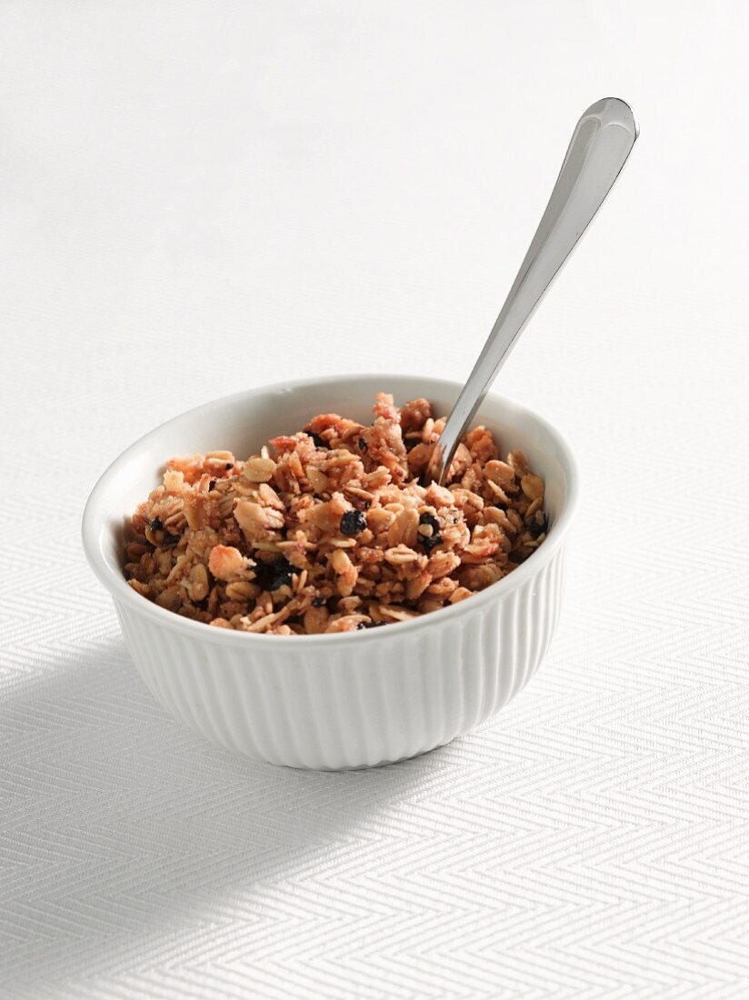 A Bowl of Granola with a Spoon