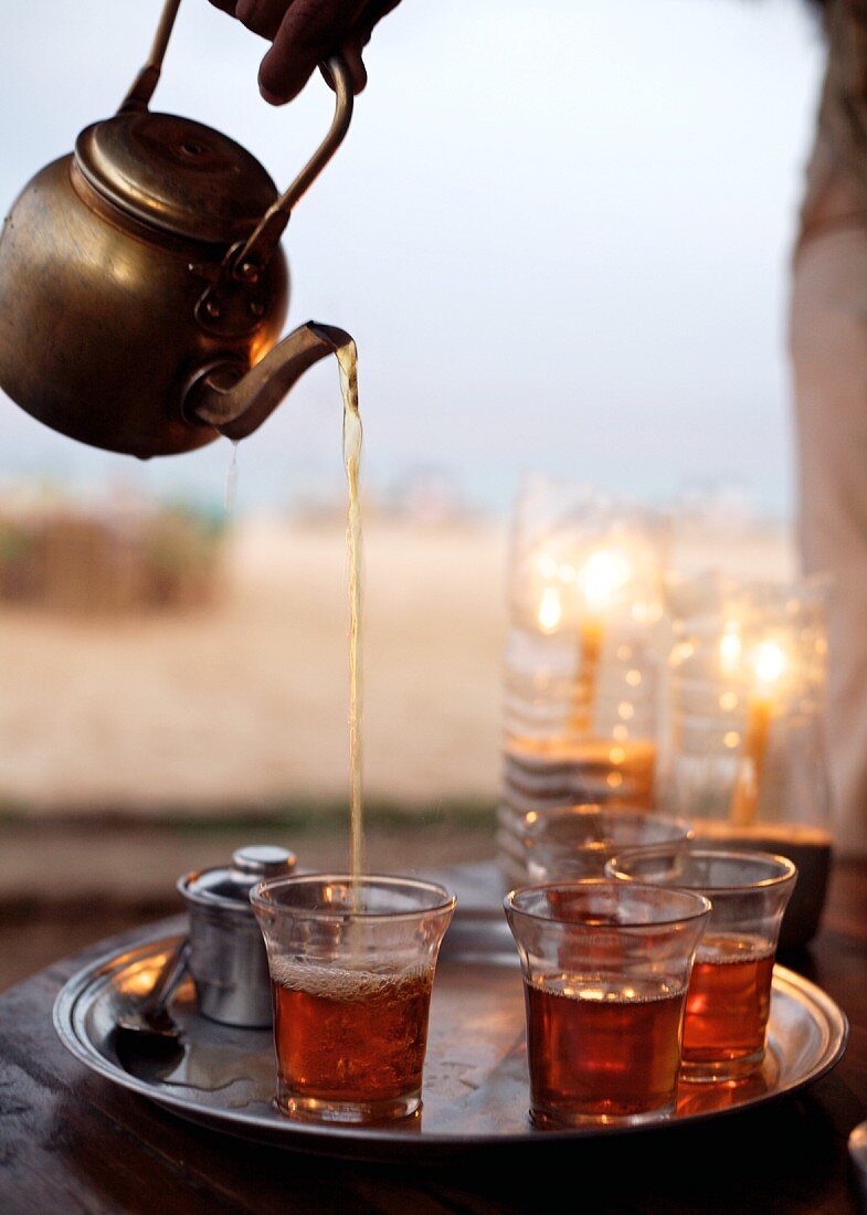 Mint tea being poured into glasses