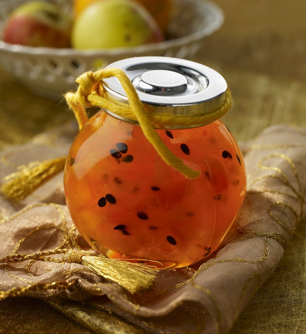 Papaya and passion fruit jam in a preserving jar