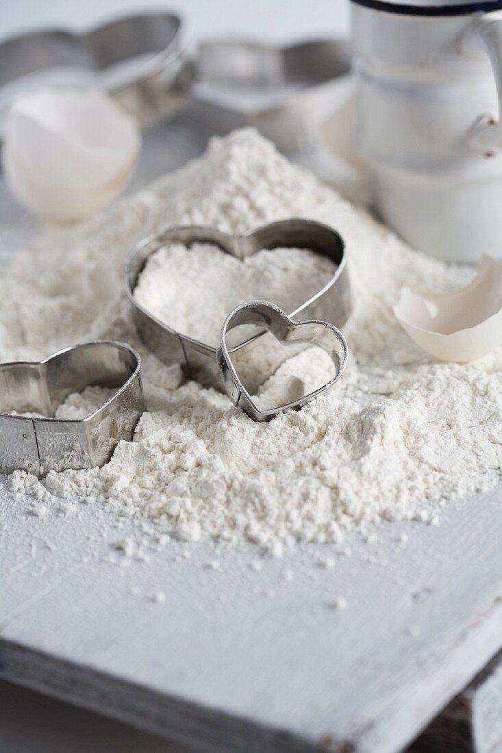Flour, heart-shaped cutters and eggshells