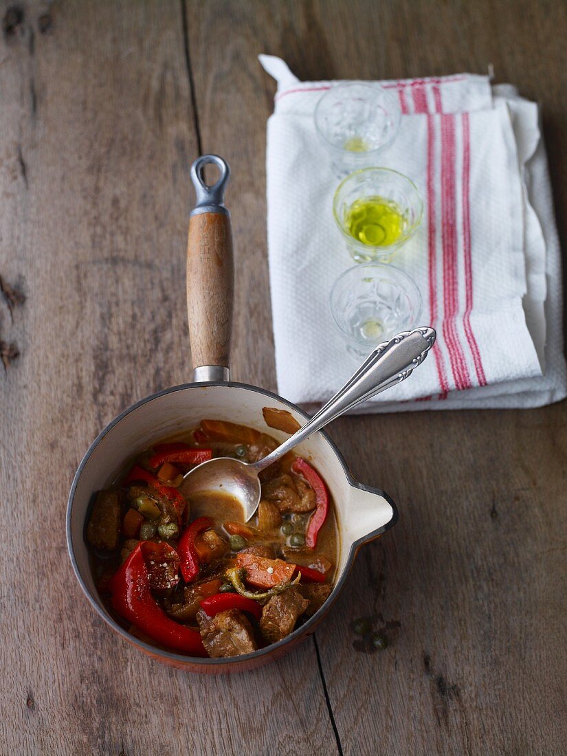 Bauernschmaus (pork, bacon and sausage in a sauce with sauerkraut, Austria) with peppers