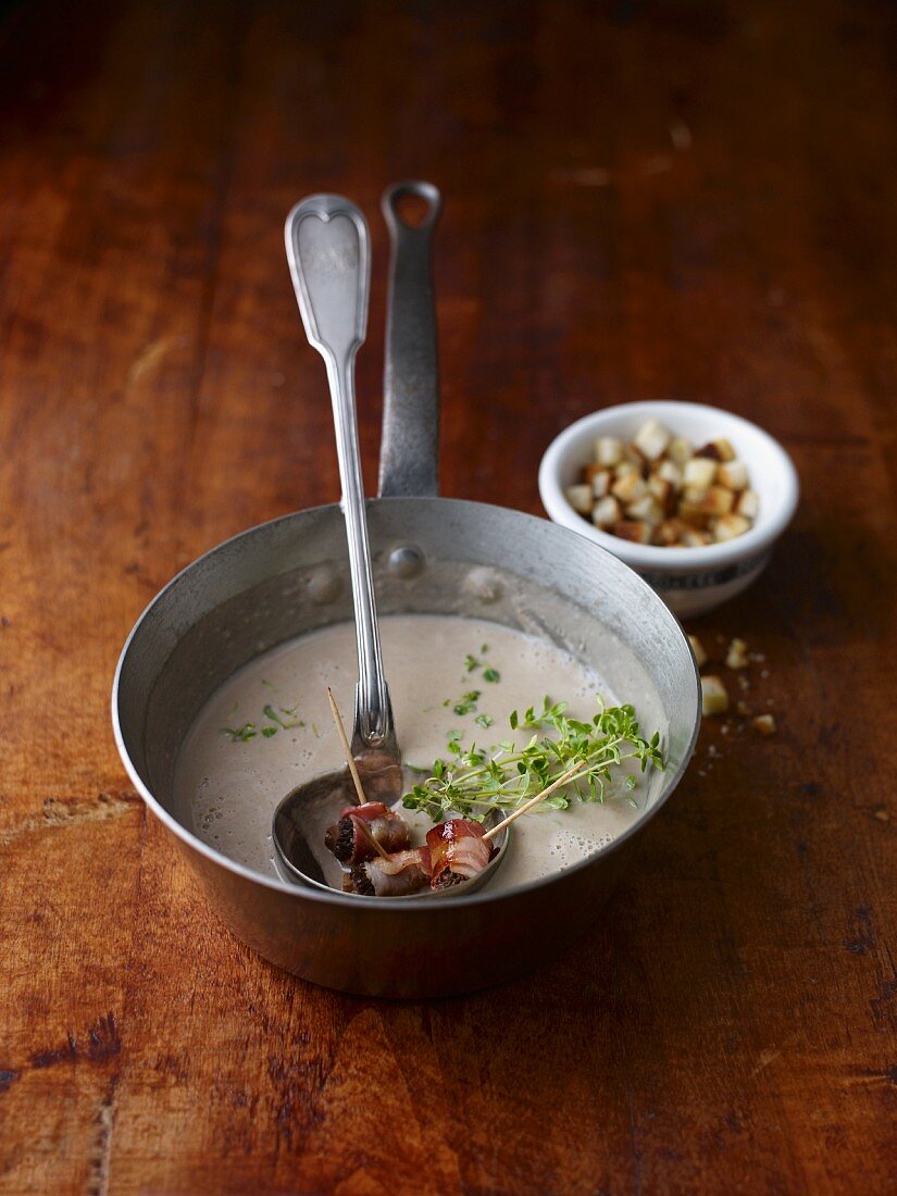 Chestnut soup with bacon-wrapped prunes and croutons