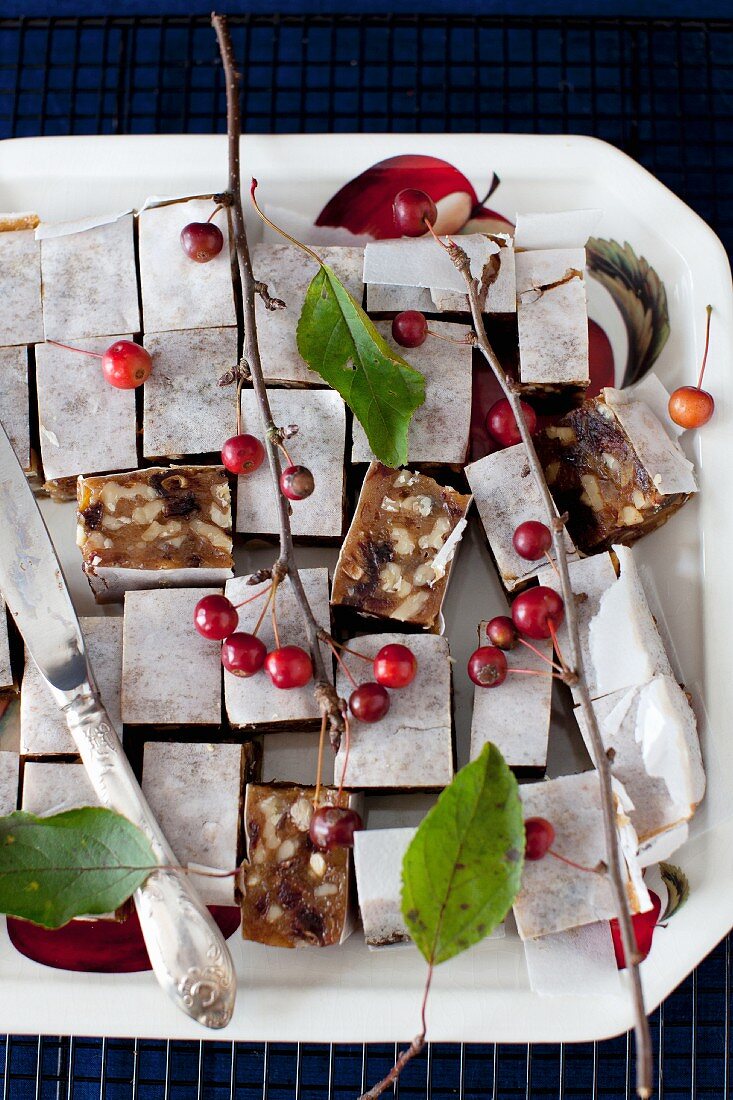 Panforte Squares on a Platter with Berries and a Knife