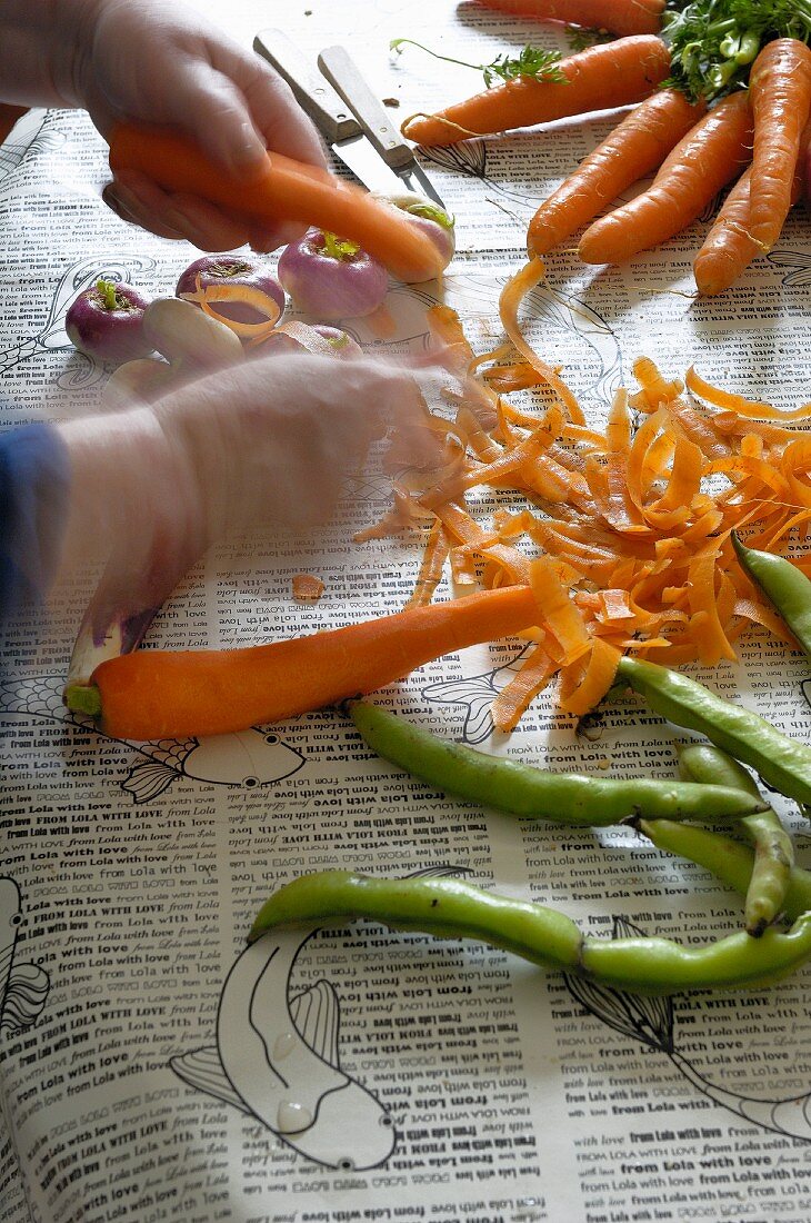 A woman's hands peeling carrots
