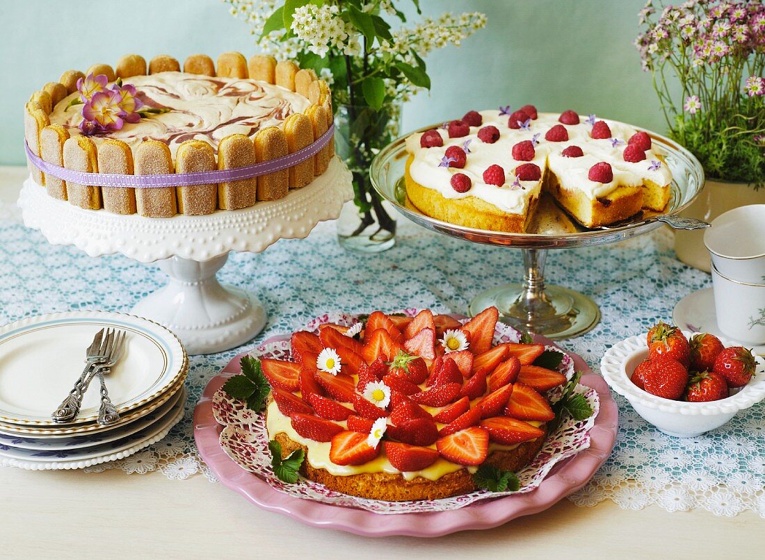 A buffet of three different summer cakes