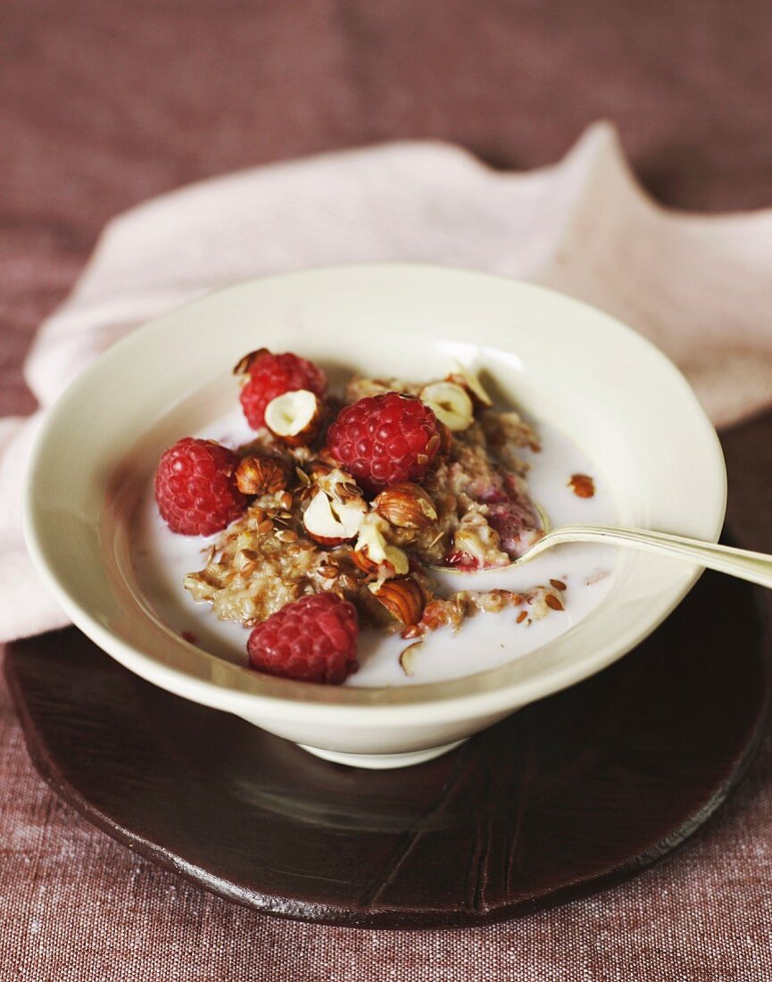 Porridge with raspberries, milk and hazelnuts