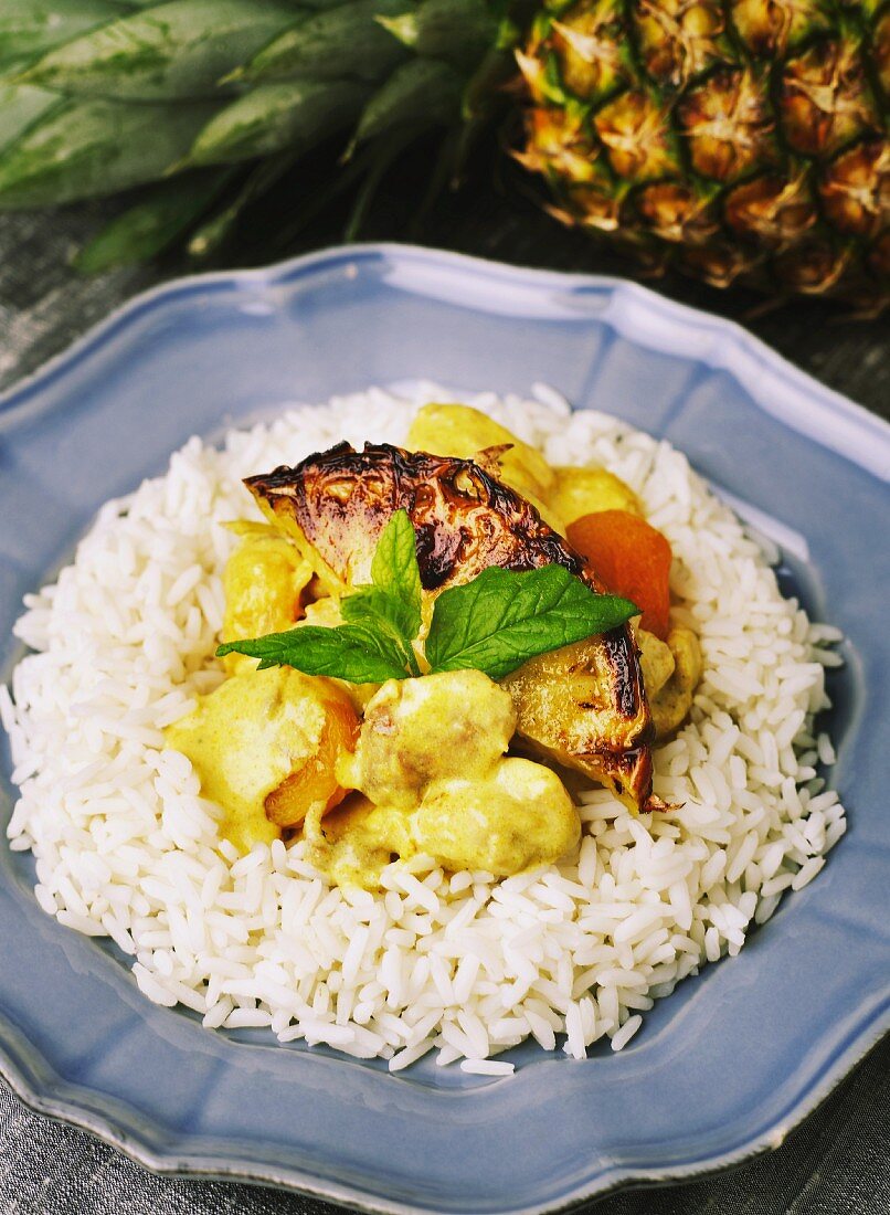 Chicken curry with pineapple and dried apricots, on a bed of rice