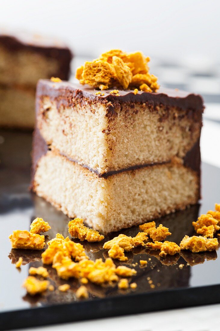 A chocolate-spread cake with crumbled pieces of honey cake