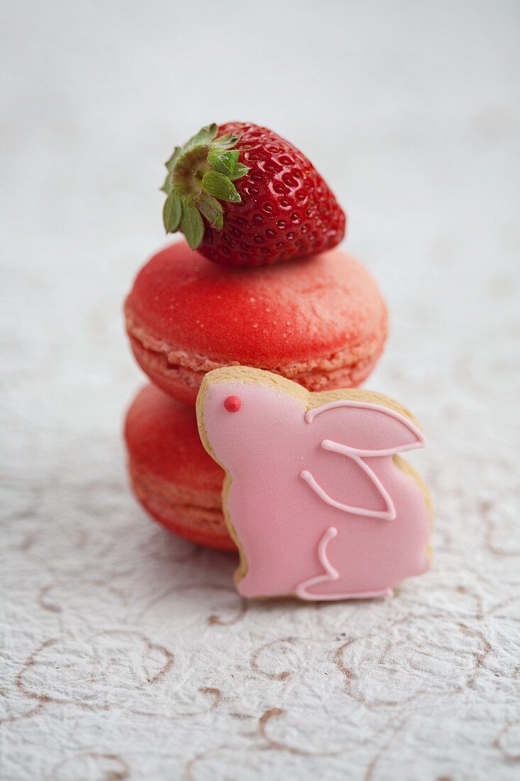 Strawberry macaroons, fresh strawberries and a rabbit-shaped biscuits
