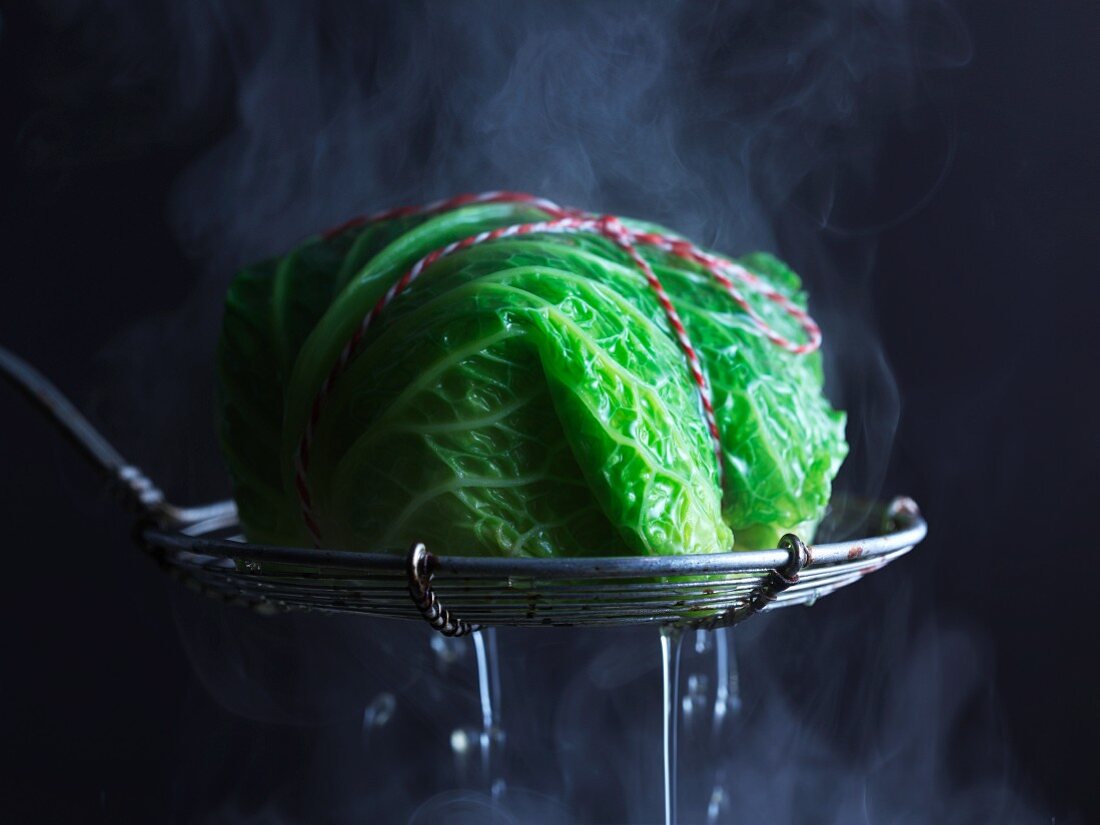 A parcel wrapped in savoy cabbage in a steamer