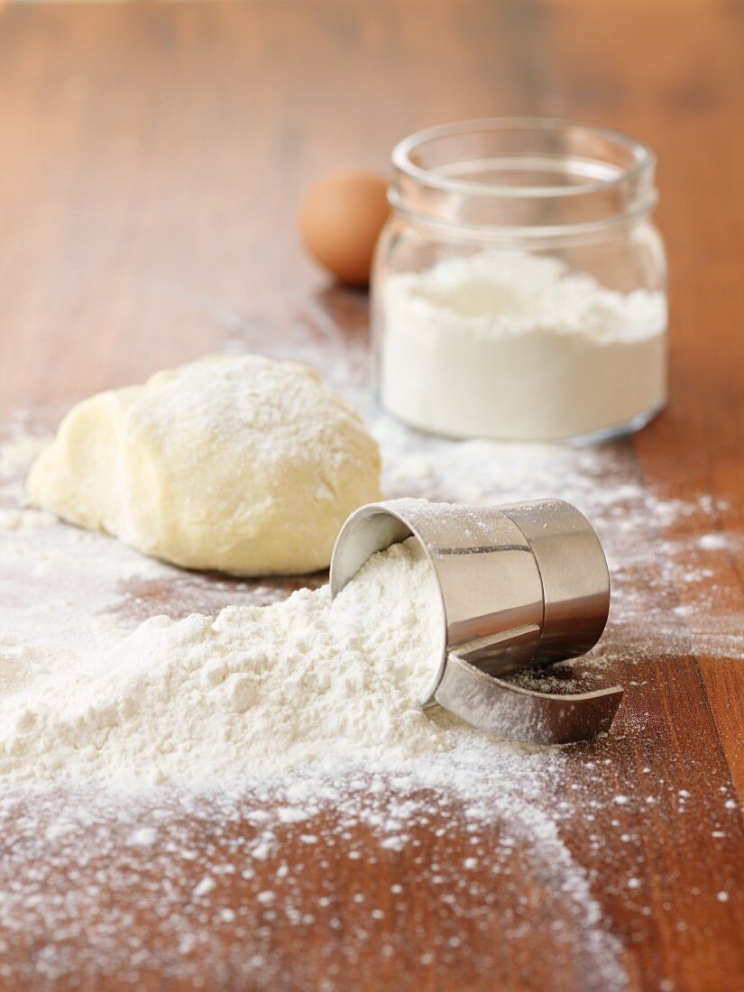 Flour and dough on a wooden surface